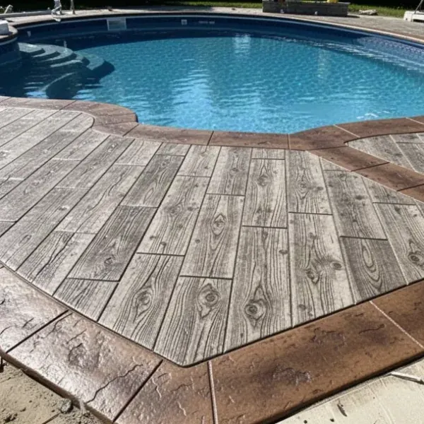 Wood plank stamped concrete around backyard pool